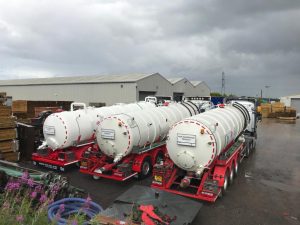 3 septic tank trucks parked side by side